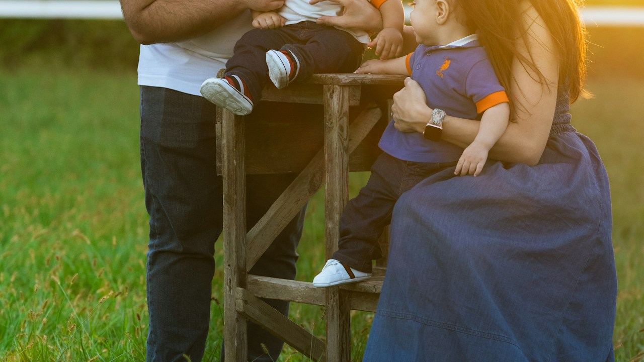 Parents and children together outdoors at sunset
