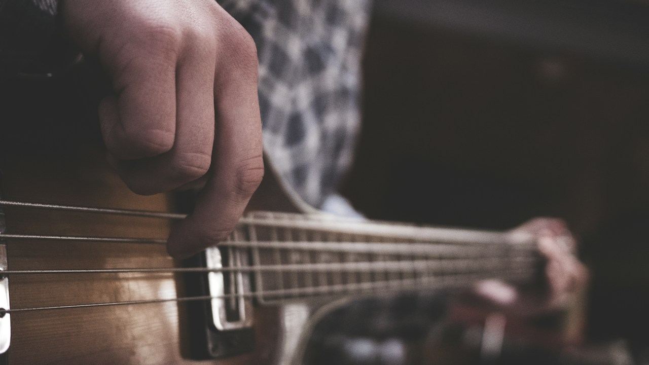 Musician playing an acoustic guitar